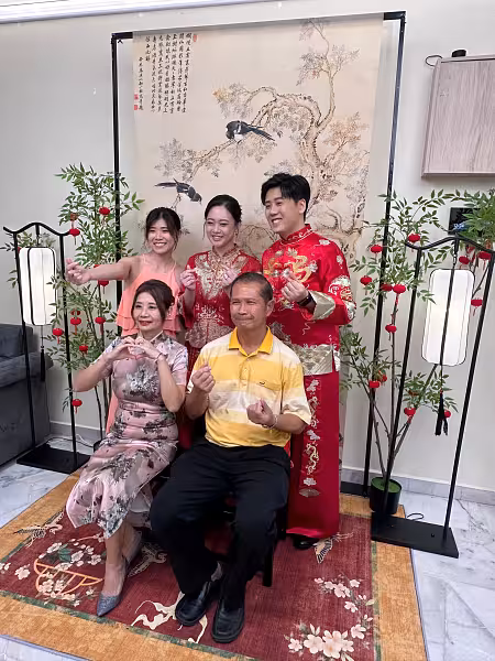 Chinese tea ceremony backdrop with ink painting hanging cloth, nandina floor ornaments, arch lantern lamps, and red floral carpet