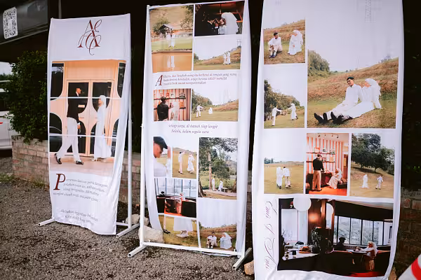 Three white adjustable rectangle screen arch frames displaying printed photo collage and calligraphy banners outdoors