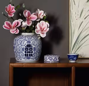 Oriental Blue and White Floral Pattern Round XI Vase styled on a wooden console with pink magnolia blooms, beside a lidded jar and tea cup