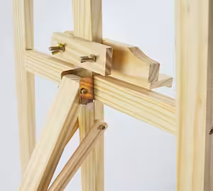 Close-up of the Easel Stand 175 cm adjustable ledge and brass bolt hardware on natural pine wood tripod frame