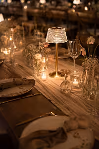 Crystal Shade Portable Dining Table Lamp casting warm golden light along a long wedding banquet table lined with votive candles and bud vases