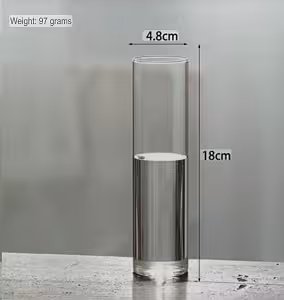 Minimalist Cylinder Clear Glass Vase shown with dimension annotations: 4.8cm diameter, 18cm tall, 97g, on a grey stone surface