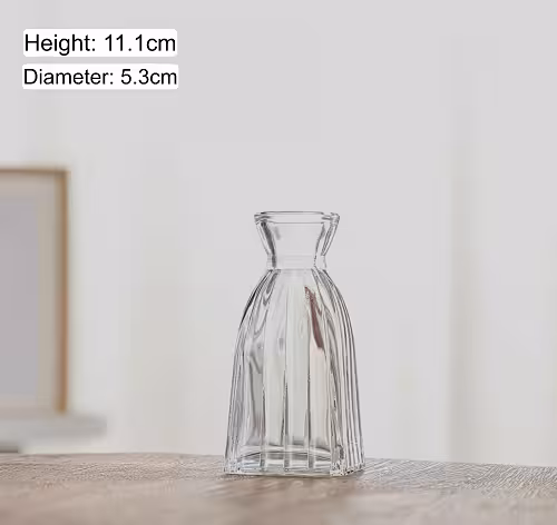 Mini Clear Glass Flower Vase Type F on a wooden surface, showing its 11.1cm height and 5.3cm diameter with a softly blurred background