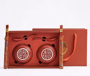 Oriental Red Lantern Bowl Set with two red ceramic bowls bearing Chinese characters, red spoons, gold-tipped chopsticks, and a red gift box